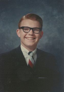 Steven Earl Parent wearing eyeglasses and a black suit with a tie.