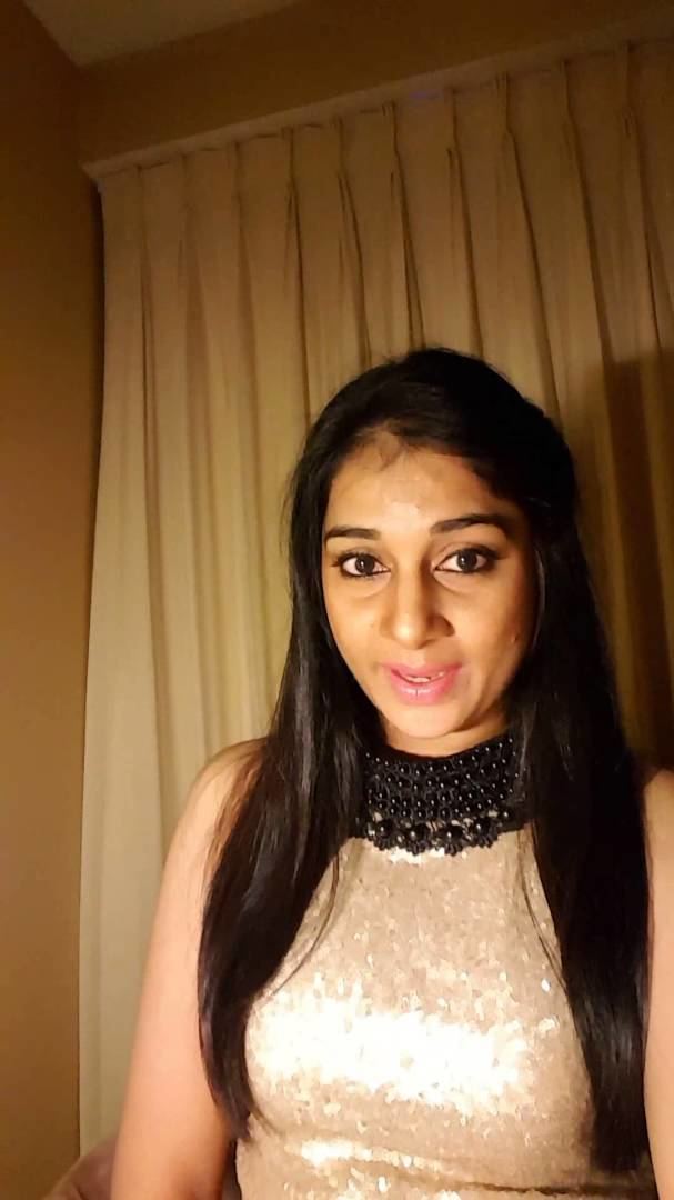 Sudeepa Pinky wearing a cream shiny sleeveless blouse and black beaded necklace