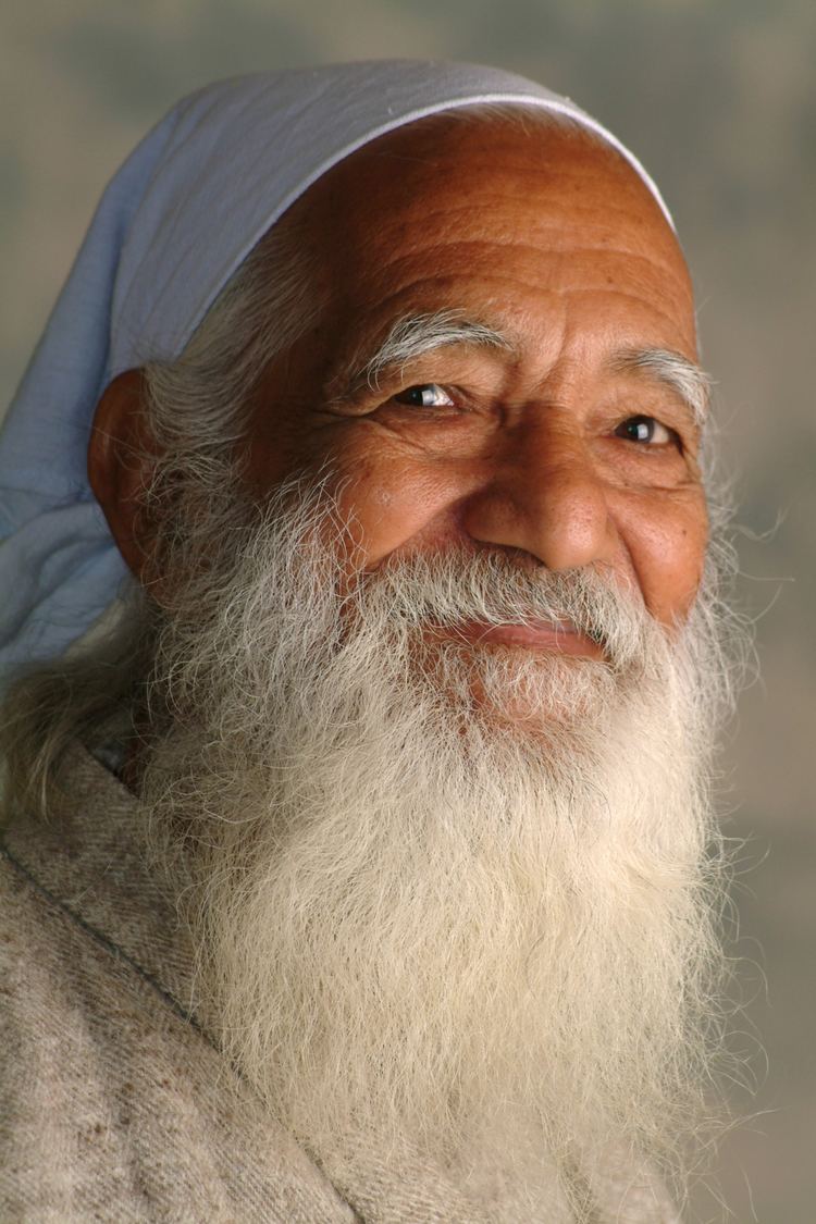 Sunderlal Bahuguna with a white long mustache and beard, wearing a white bandana.