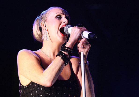 Susan Ann Sulley of the band Human League performs on stage while wearing a black sleeveless top during the V Festival 2009
