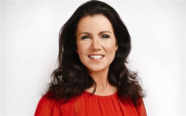 Susanna Reid smiling and wearing a red blouse.