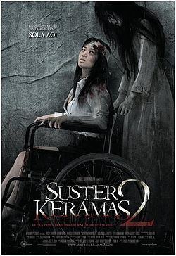 The advertisement poster of the movie Suster Keramas 2 (2011), Sola Aoi (left) is anxious  looking up with bandages over her head while sitting on a wheelchair, has long black hair wearing white long sleeve polo with blood over her shoulders and black skirt. A female ghost (right) looking at Sola Aoi while holding the wheelchair has long black hair and is wearing a long white dress.