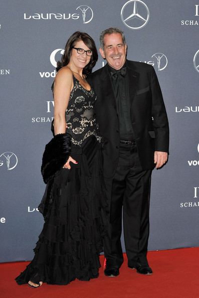 Suzanne Danielle smiling with Sam Torrance while wearing a black gown at the Laureus World Sports Awards, London, Britain