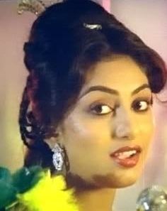 Swapna (actress) wearing a yellow shirt and earrings