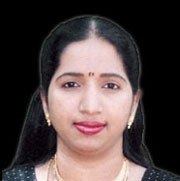 Swarnalatha's tight lipped smile while wearing earrings and necklace