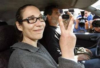 Tali Fahima with a tight-lipped smile while inside the car and showing a peace sign after she released from Naveh Tirza Prison