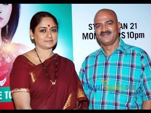 Talluri Rameshwari wearing red dress with gold details and Vijay Kashyap in his blue checkered polo