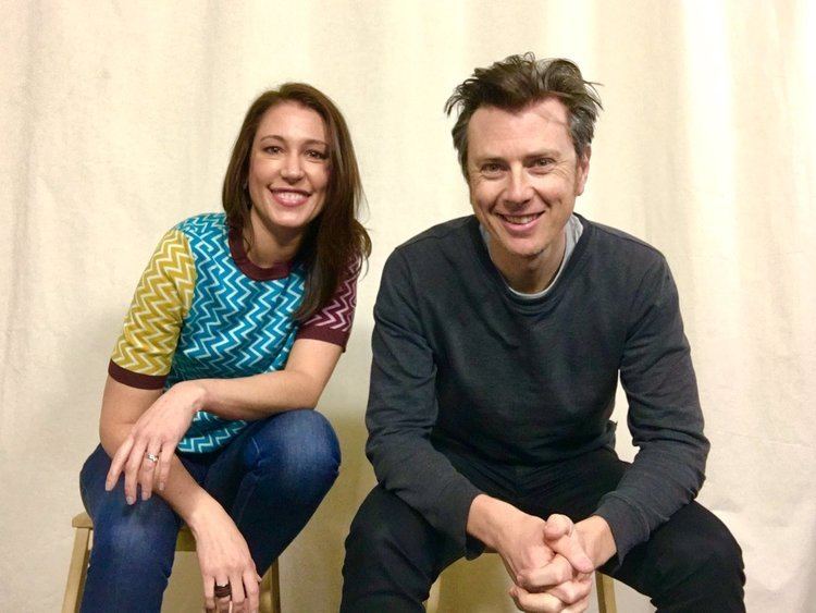 Tamara Oudyn wearing a colorful shirt and her friend Al Reid wearing black long sleeves shirt