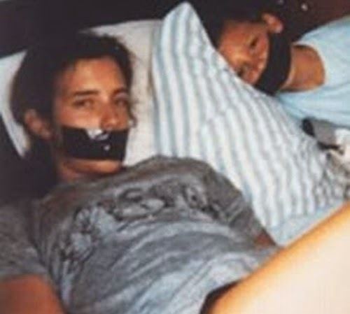 A teenage girl and a boy with hands tied up and their mouths taped shut while lying on the bed. The girl is believed to be Tara Calico