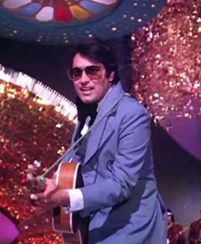 Tariq Khan (actor) while holding a guitar and performing on stage