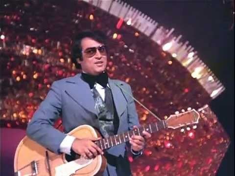 Tariq Khan (actor) while holding a guitar and performing on stage