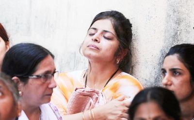 Friends and relatives mourn during the funeral of late child actor Taruni Sachdev and her mother Geeta in Mumbai