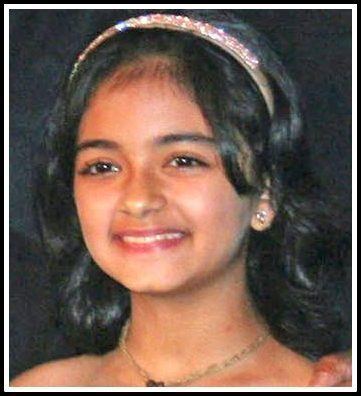 Taruni Sachdev smiling while wearing a headband, earrings, and necklace