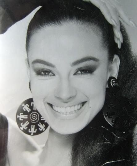 Tatiana Thumbtzen smiles while wearing pair of earrings (black and white)