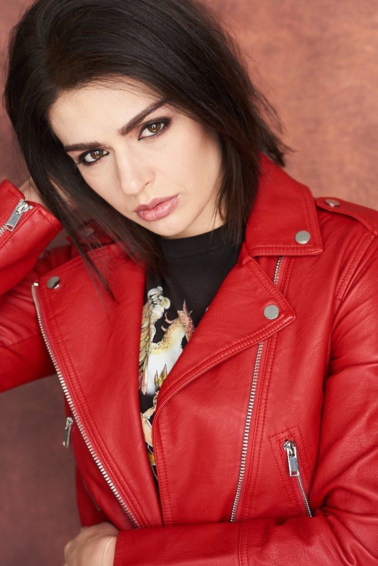 Tatiana Zappardino looking fierce in a short hair while wearing a red leather jacket and black printed shirt