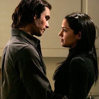 Michelle Borth and Luke Kirby are looking at each other in a scene from Tell Me You Love Me, a 2007 American cable television drama series. Michelle is wearing a black long sleeve top while Luke is wearing a black jacket.