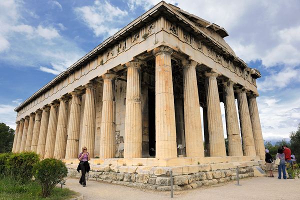 The Temple of Hephaestus located in the northern part of the Ancient Agora of Athens with people visiting the site