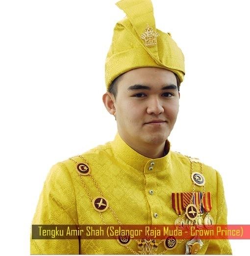 Tengku Amir Shah smiling while wearing royal attire a yellow long sleeves with badges and hat