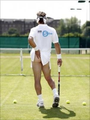 A tennis player holding a racket, showing his butt without underwear, and wearing a white t-shirt, bandana, and rubber shoes