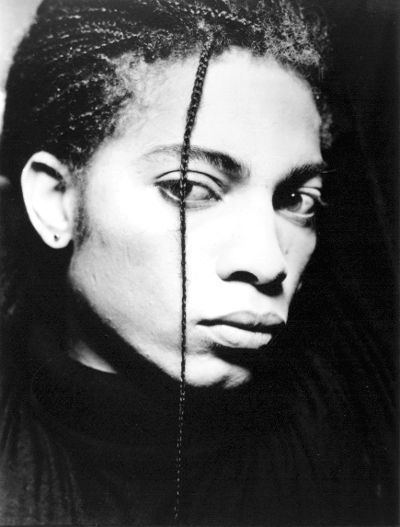 Terence Trent D'Arby looking on his side with a box braid while wearing a t-shirt