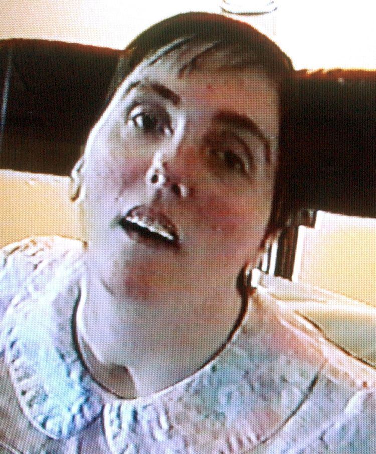 Terri Schiavo with a mouth open and wearing a white blouse