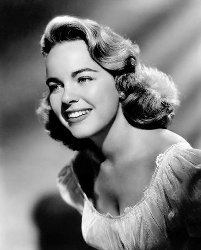 Smiling Terry Moore in black and white wearing a dress