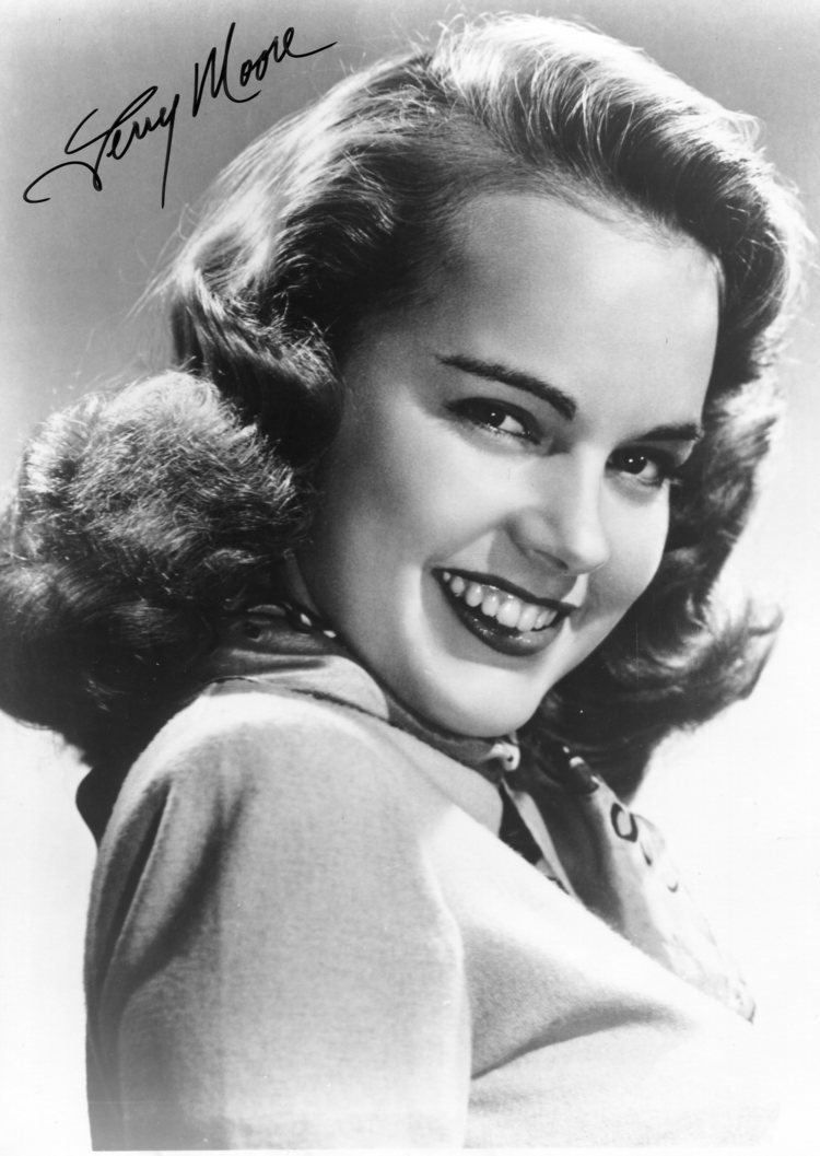 Smiling Terry Moore in black and white with his signature