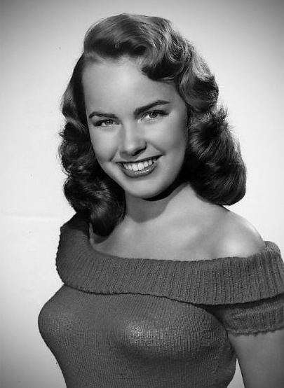 Smiling Terry Moore wearing a dress in white background