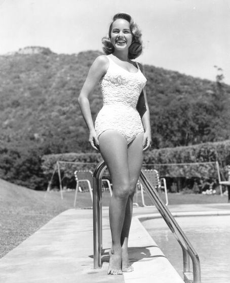 Terry Moore wearing a swimsuit beside at swimming pool