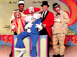 Ringmaster Ned, Mr. Bob, Sandy, Cooky the Cook, and Bozo smiling all together at The Bozo Show