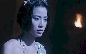 Ellen Chan as May in a dark alley looking at something in a scene from The Eternal Evil of Asia, 1995.