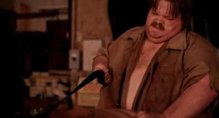 Scene from the movie "The Hospital" featuring a fat guy with a mustache and wearing a brown polo shirt.