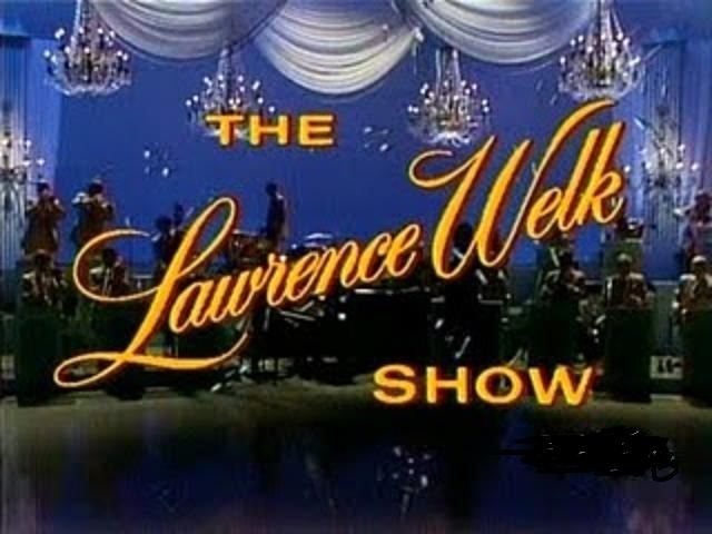 A picture of the show with a theme of The Lawrence Show with chandeliers and white curtains featuring the musical band.