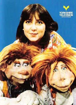 Victoria Williams smiling with the two Riddlers Mossop and Tiddler in the British children's programme, The Riddlers