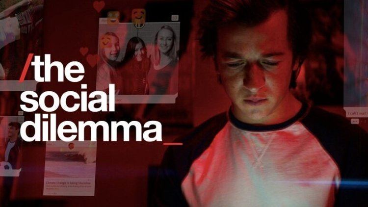 On the left, is the title of the docudrama film, The Social Dilemma while on the right, Skyler Gisondo looking at his cellphone
