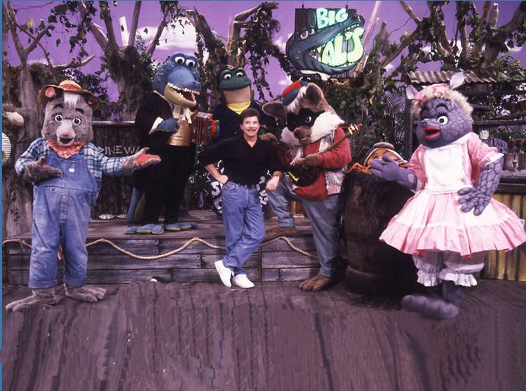 The Swamp Critters of Lost Lagoon casts- Billy Bob Possum, Big Al Gator, Ima Dilla, Joe Raccoon, Gumbo Fiddler Crab, Ribbit E. Lee (from left to right), and Bobby Goldsboro in the center