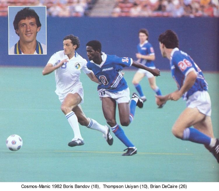 Boris Bandov, Thompson Usiyan, and Brian DeCaire are playing football and Thompson is wearing the number ten blue jersey