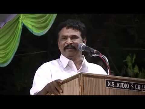 Thozhar Thiyagu giving a speech while wearing white long sleeves
