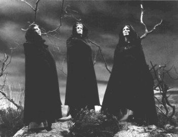 Three Witches wearing a black hooded dress