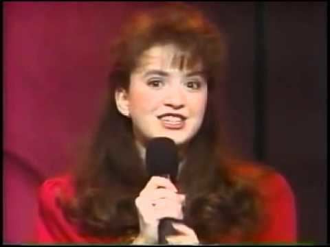 Tiffany Brissette wearing a red shirt while holding a microphone