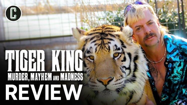 Poster of Tiger King, an American true-crime documentary streaming television series, starring Joe Exotic with blonde hair beside a tiger, wearing a blue-green polo shirt.