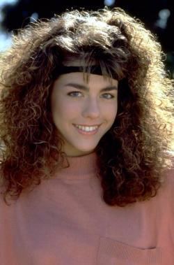 Tina Caspary smiling and wearing a pink blouse