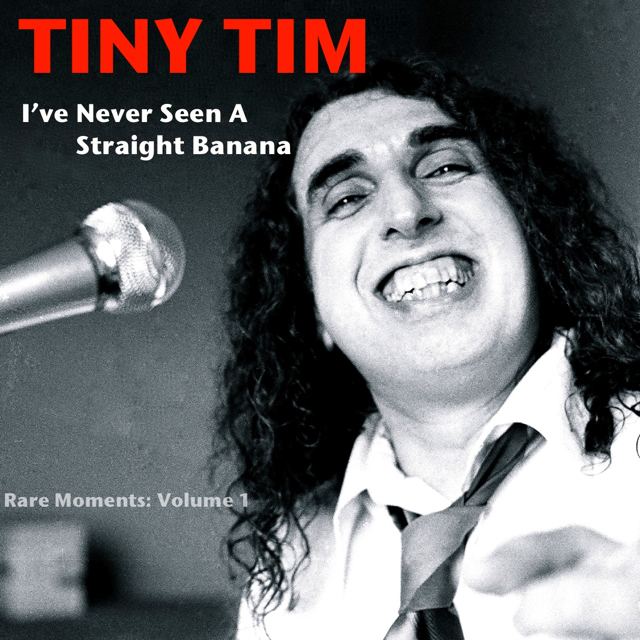 Poster of Tiny Tim with curly hair, wearing long sleeves and a tie with a microphone in front of him.