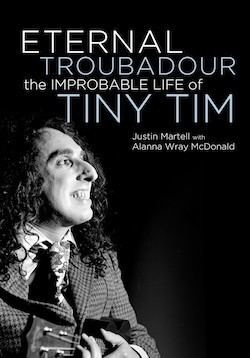 Poster of Tiny Tim with curly hair, wearing a checkered suit and playing a ukelele.