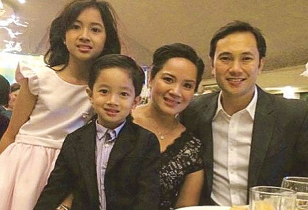 TJ Manotoc smiling with his wife and children