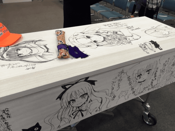 Tomohiro Matsu Japanese novelist goes out in animestyle in coffin illustrated with