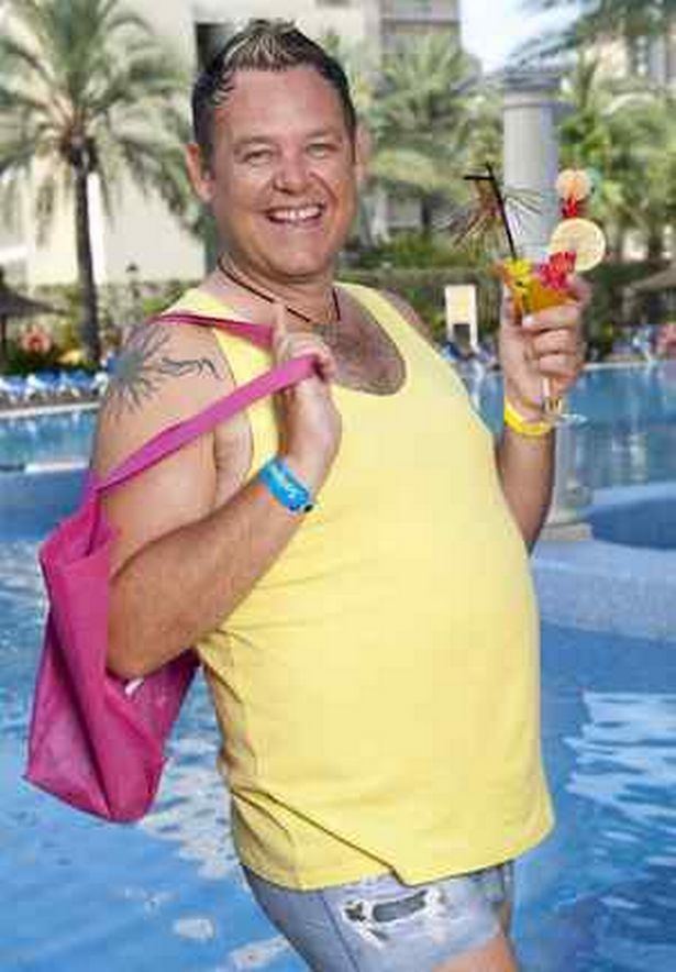 Tony Maudsley who will be acting as hairstylist Kenneth in the hit series Benidorm smiles while wearing a yellow sleeveless shirt and short denim pants