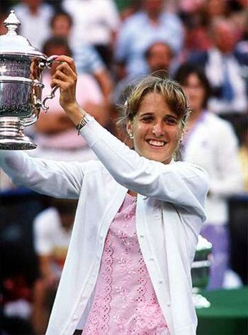 Tracy Austin Tracy Austin raising her trophy Love the eyelet dress and white