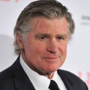 Treat Williams wearing black coat, white long sleeves and black neck tie