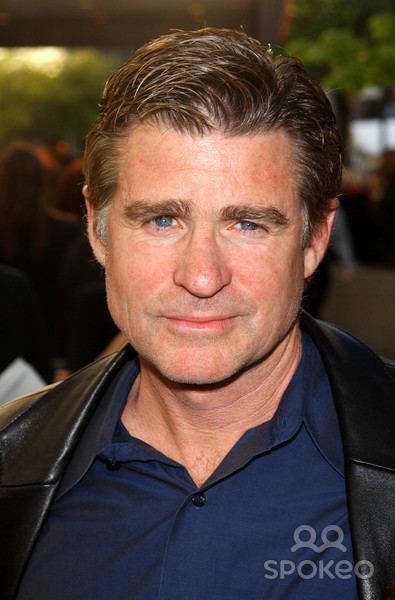 Treat Williams wearing black coat and blue long sleeves